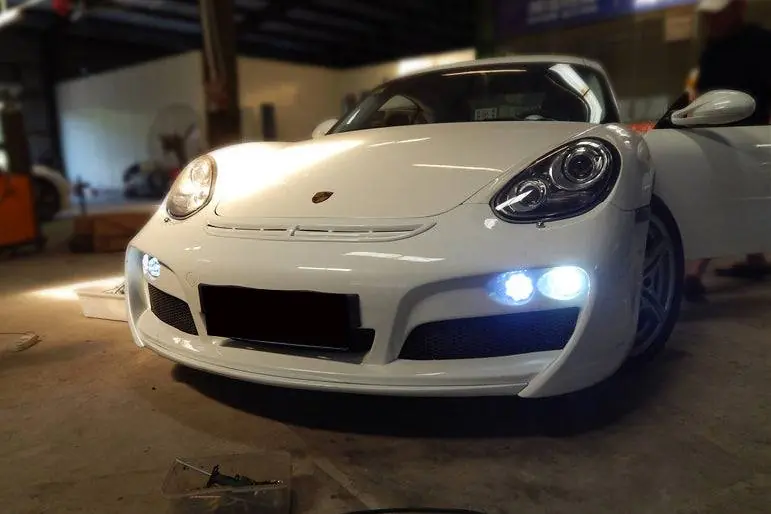 Carbonado 2009-2012 Porsche Cayman Boxster 987 TA Style Front Bumper with LED Lights